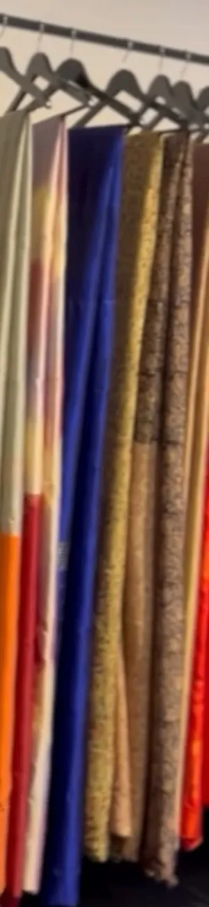 Cream, royal blue and gold sarees side by side